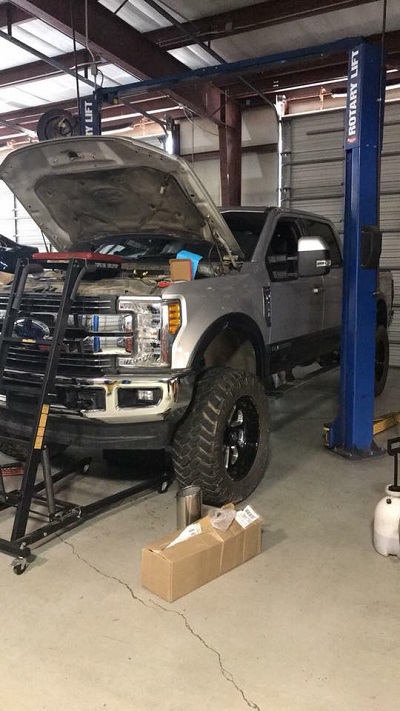 Truck with hood up in service bay